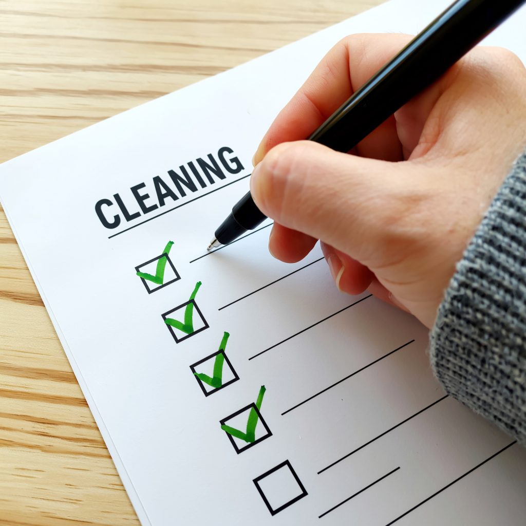 Office manager signing a commercial cleaning checklist in Canberra