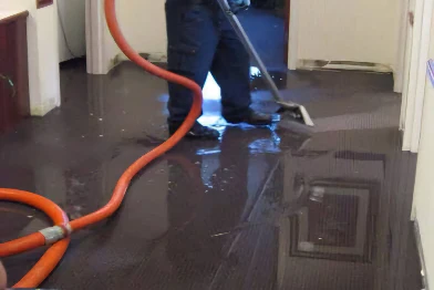 Flooded carpet having water extracted with professional commercial cleaning equipment in Canberra
